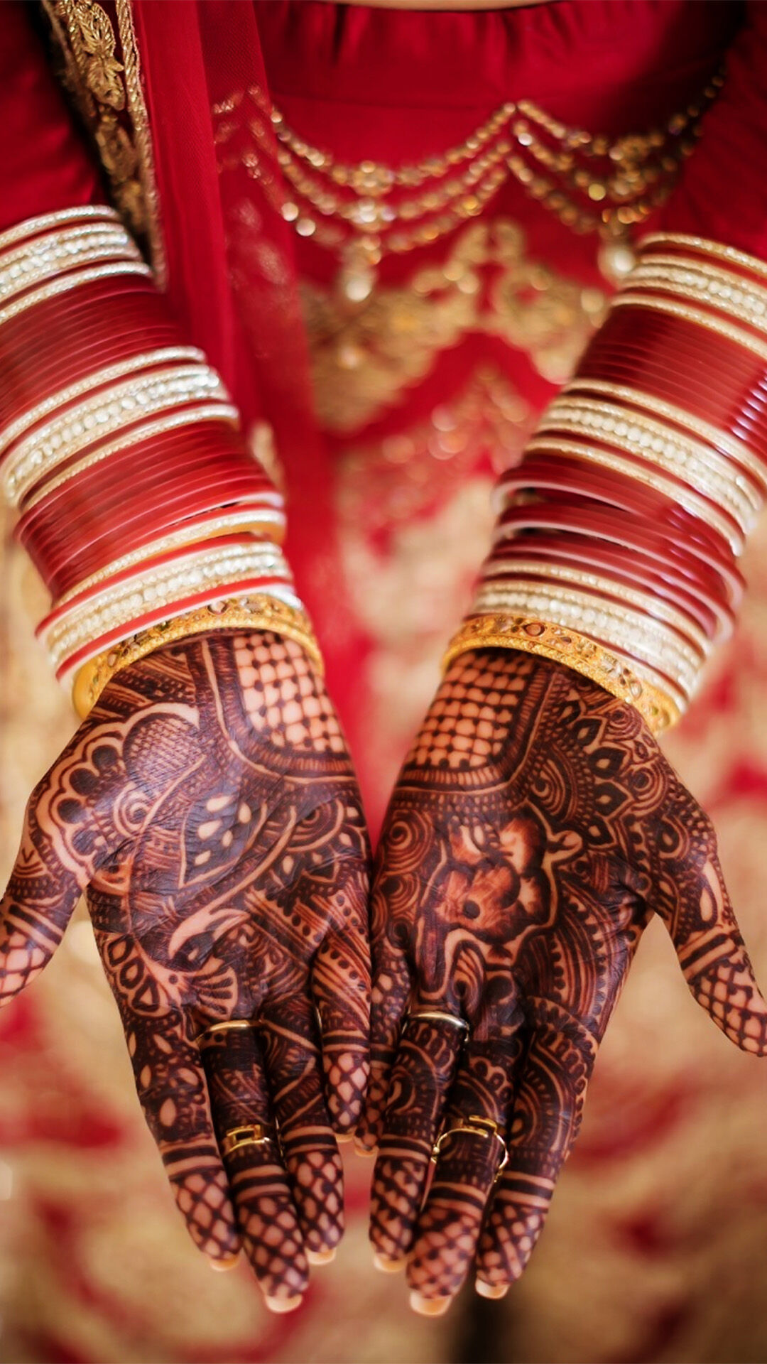 Close-up of a bride elegantly flaunting her stunning Mehendi design on her hands